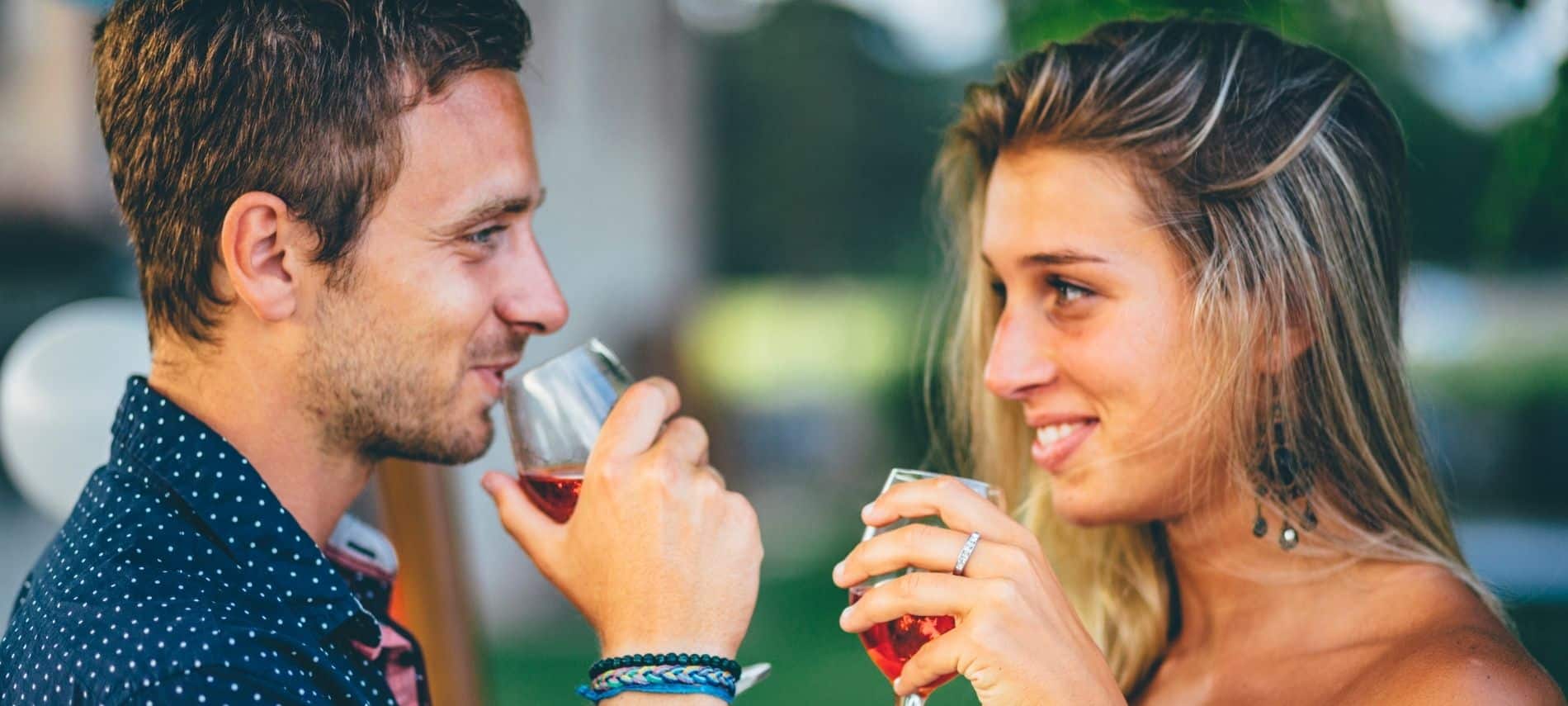 couple drinking wine and looking lovingly in each other’s eyes