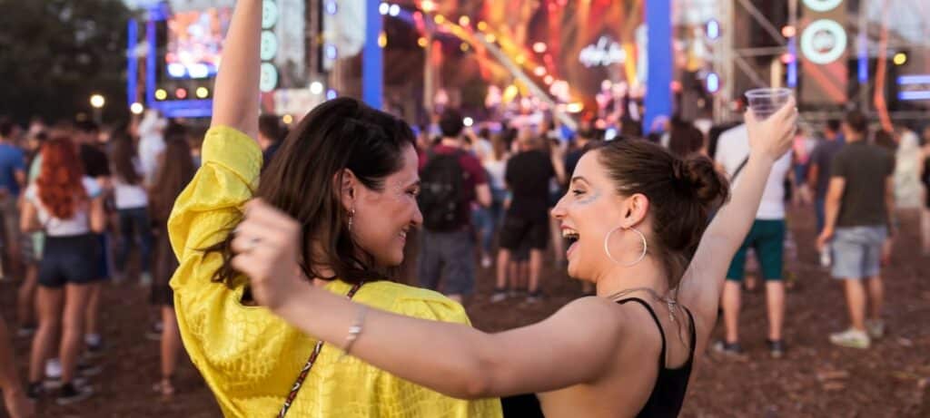 ladies dance to music at an outdoor music festival