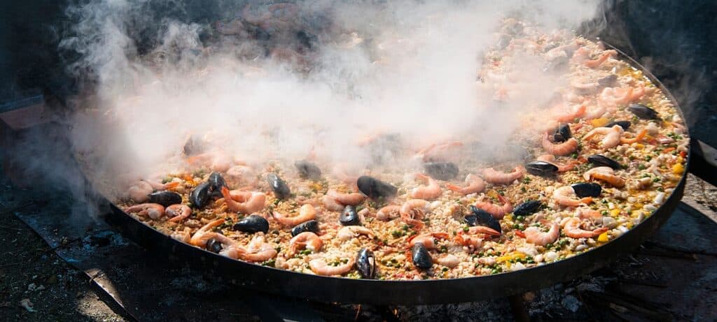 a large steaming pan of seafood paella